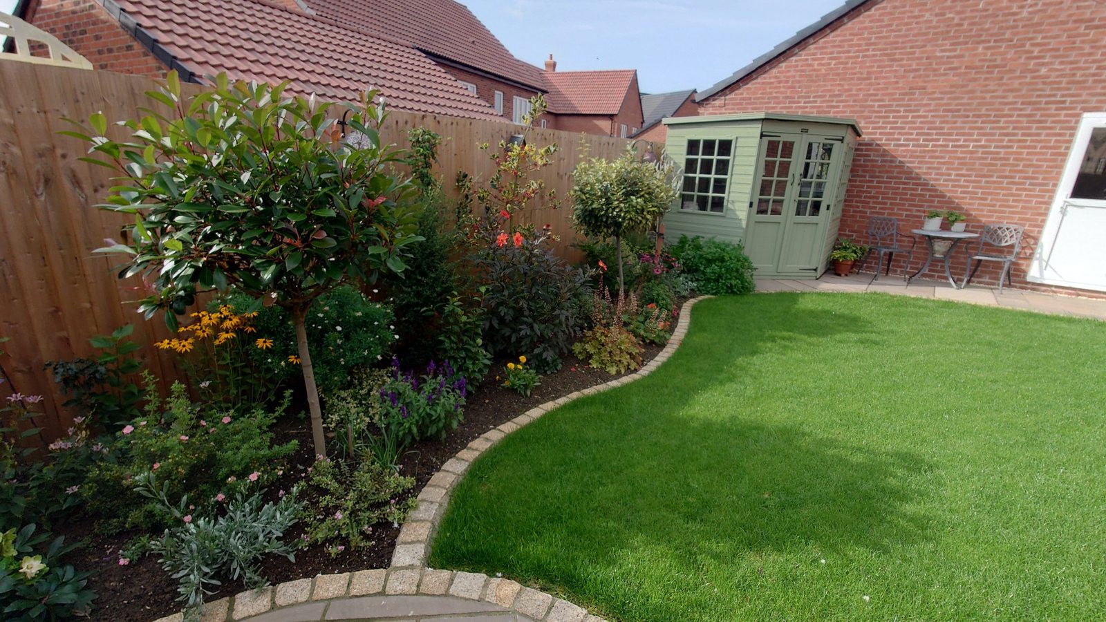 Landscaped garden with a lawn, planting and curved borders